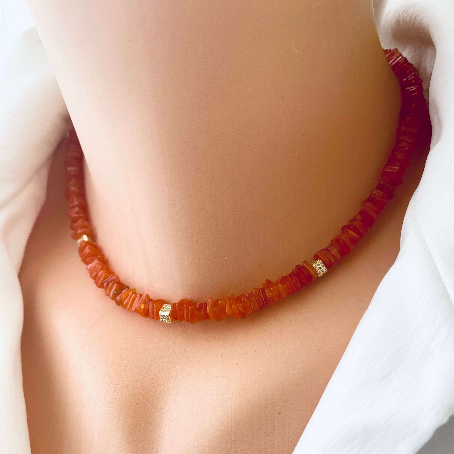Carnelian choker necklace featuring bright orange gemstone beads, handcrafted for modern elegance and vibrant style.