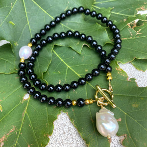 Elegant classic necklace made of black onyx beads and natural pearl. Timeless combination of black and white will suit any outfit. 
