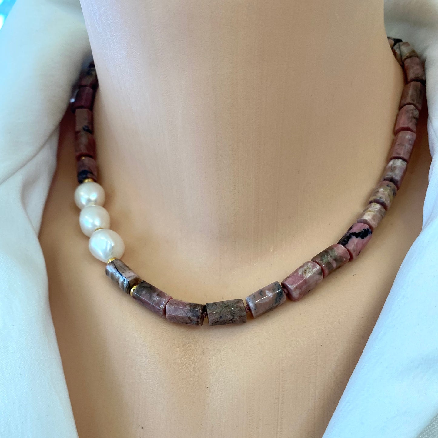 Rhodonite pearl necklace worn on neckline with pink rhodonite beads and pearls