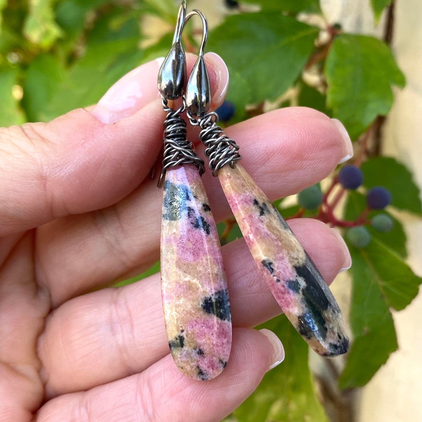 Handmade Rhodonite Teardrop Earrings with black rhodium finish showcasing pink stones and unique veining.
