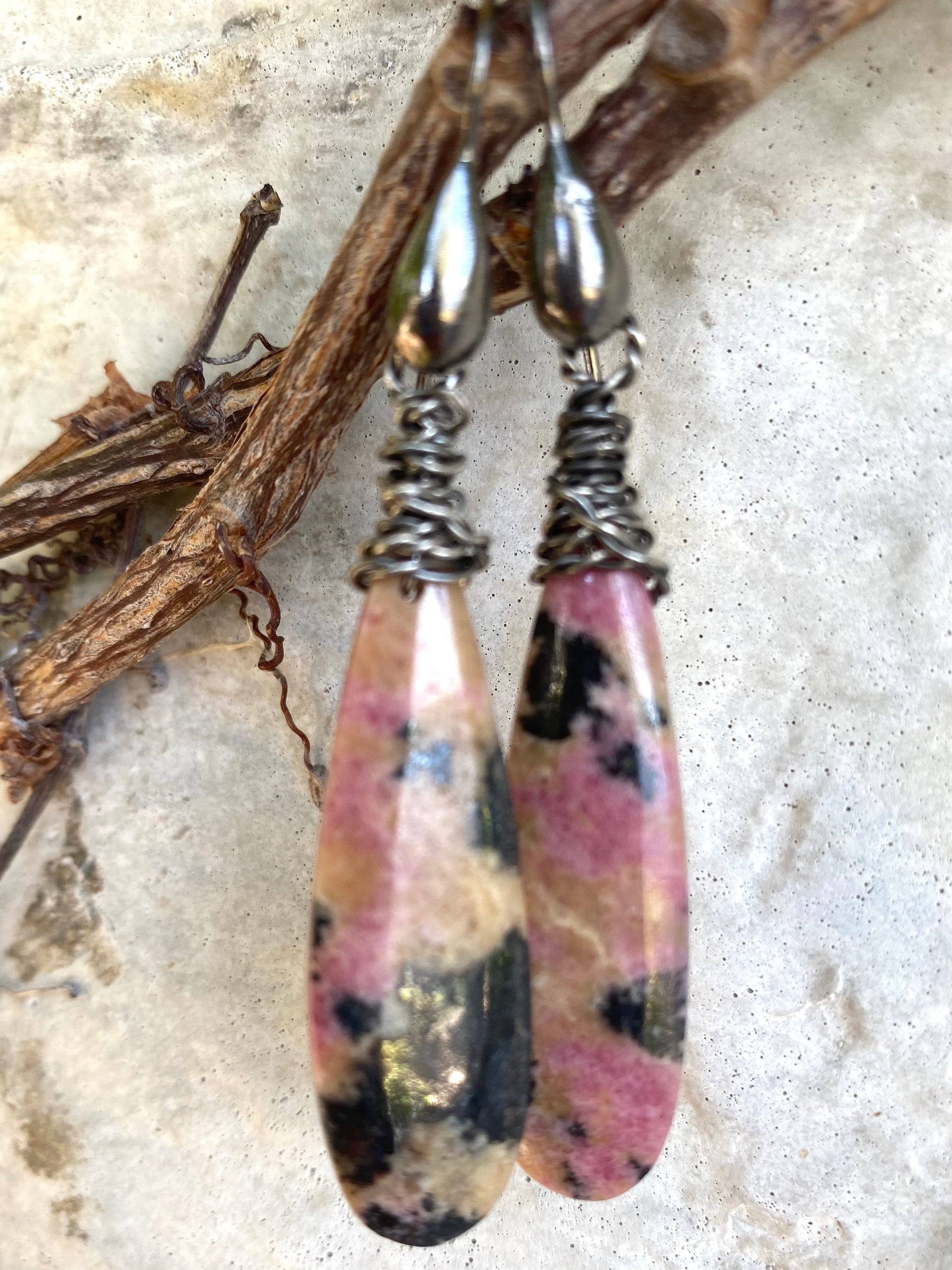 Handmade rhodonite teardrop earrings featuring pink, yellow, and black natural stone patterns