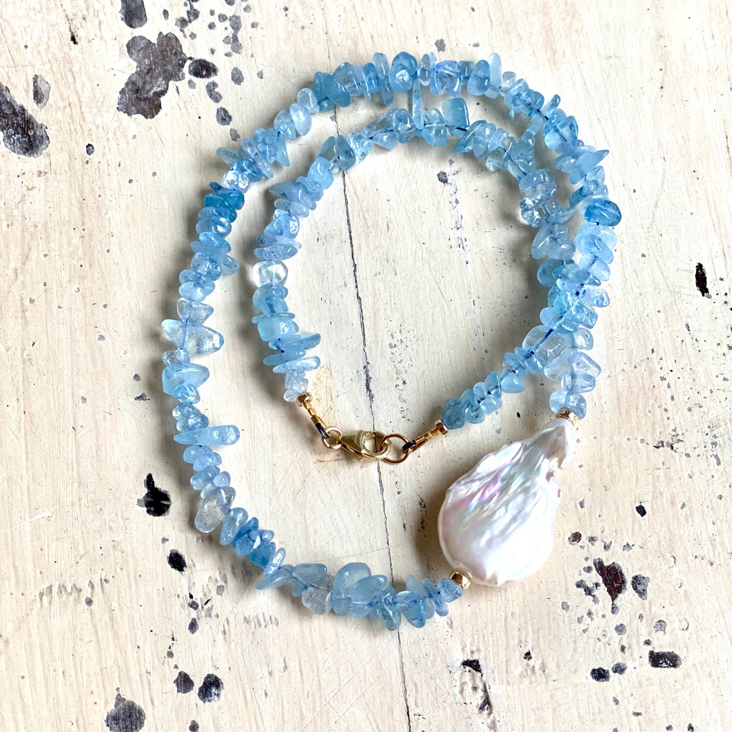 Aquamarine pearl necklace featuring natural aquamarine chips and flat freshwater baroque pearl