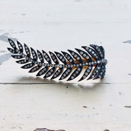 Vermeil leaf shape ring showcasing an antique finish and cubic zirconia embellishment, artistic gold statement jewelry.