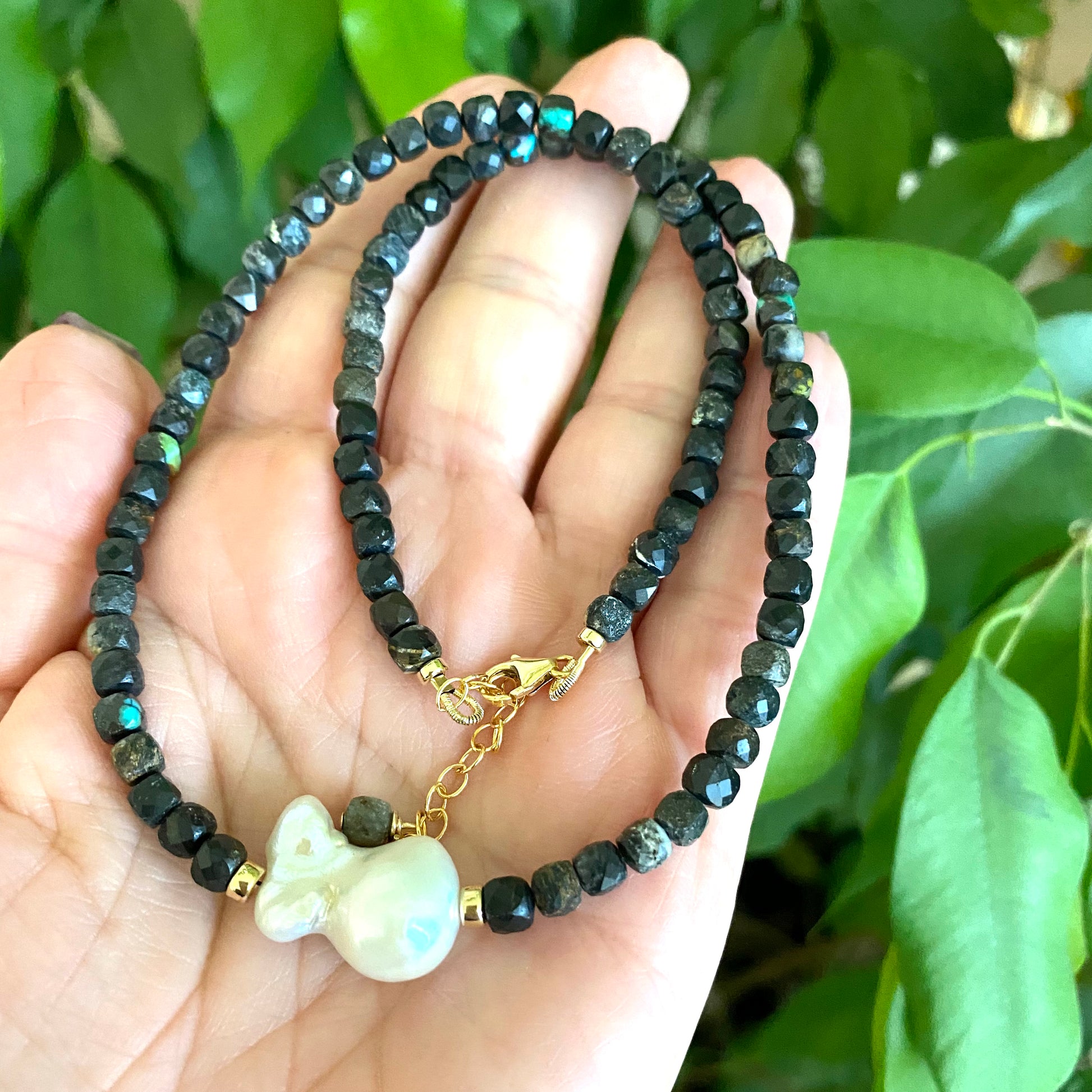 Black turquoise baroque pearl necklace showing faceted turquoise beads and organic pearl shape