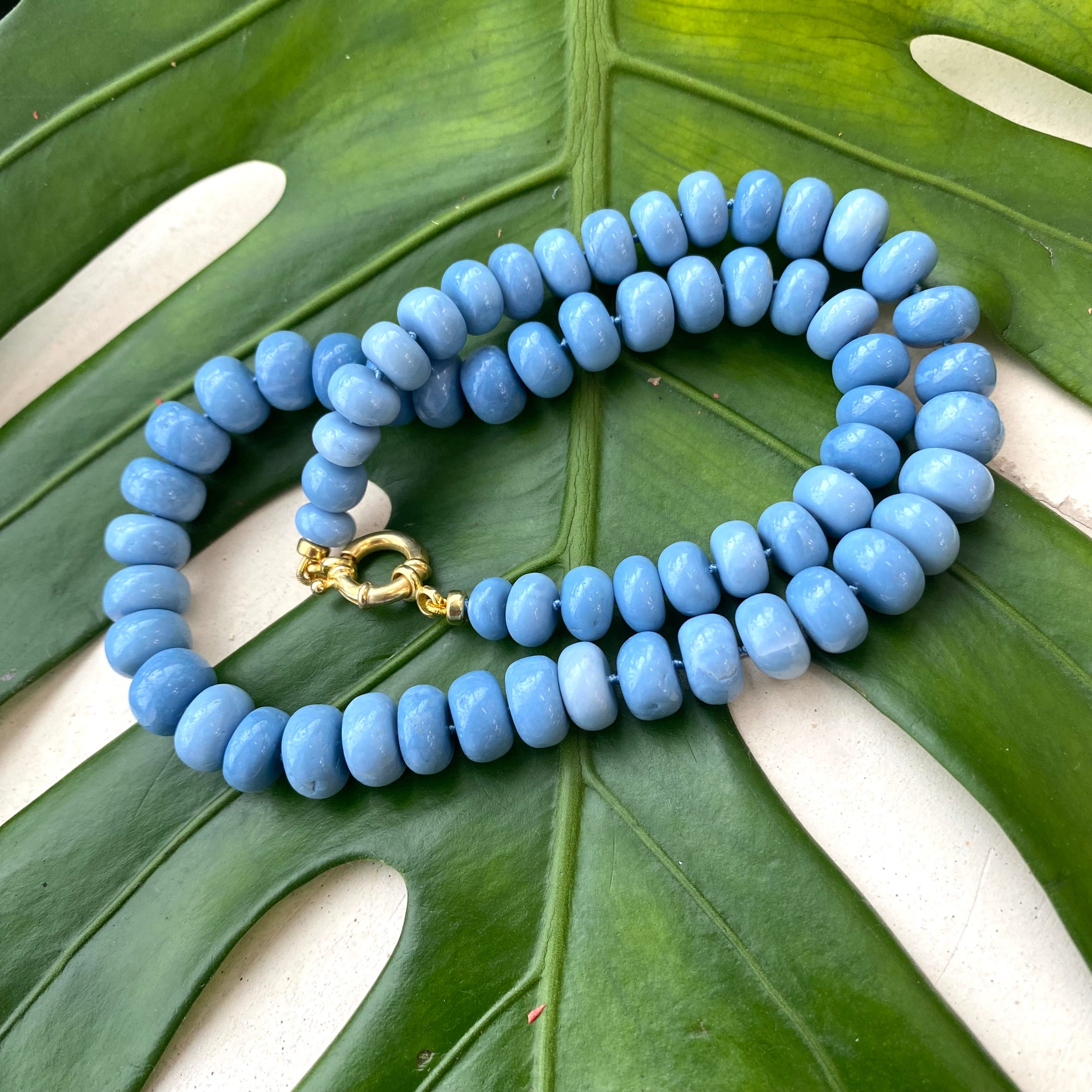 Graduated Oregon blue smooth opal candy necklace 8-11mm with gold vermeil plated sterling silver marine closure, measuring 18 or 19 inches. This modern opal jewelry piece features denim blue tones and is a perfect gift for her.