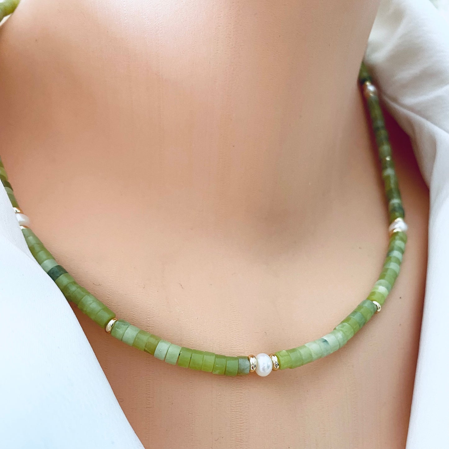 Multi gemstone choker necklaces worn at the neckline with green jade beads