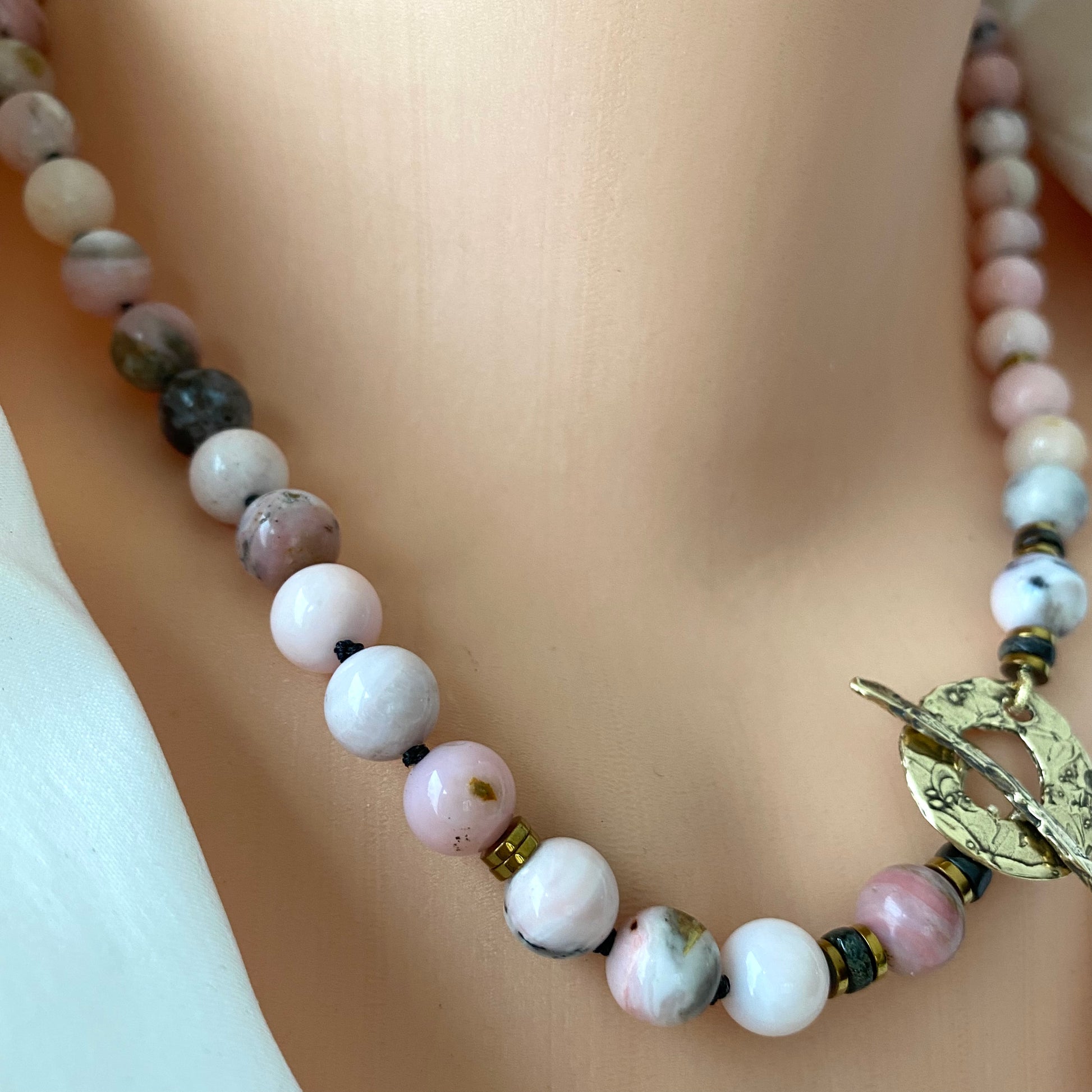 Pink opal hematite necklace close up showing pink opal beads and hematite details