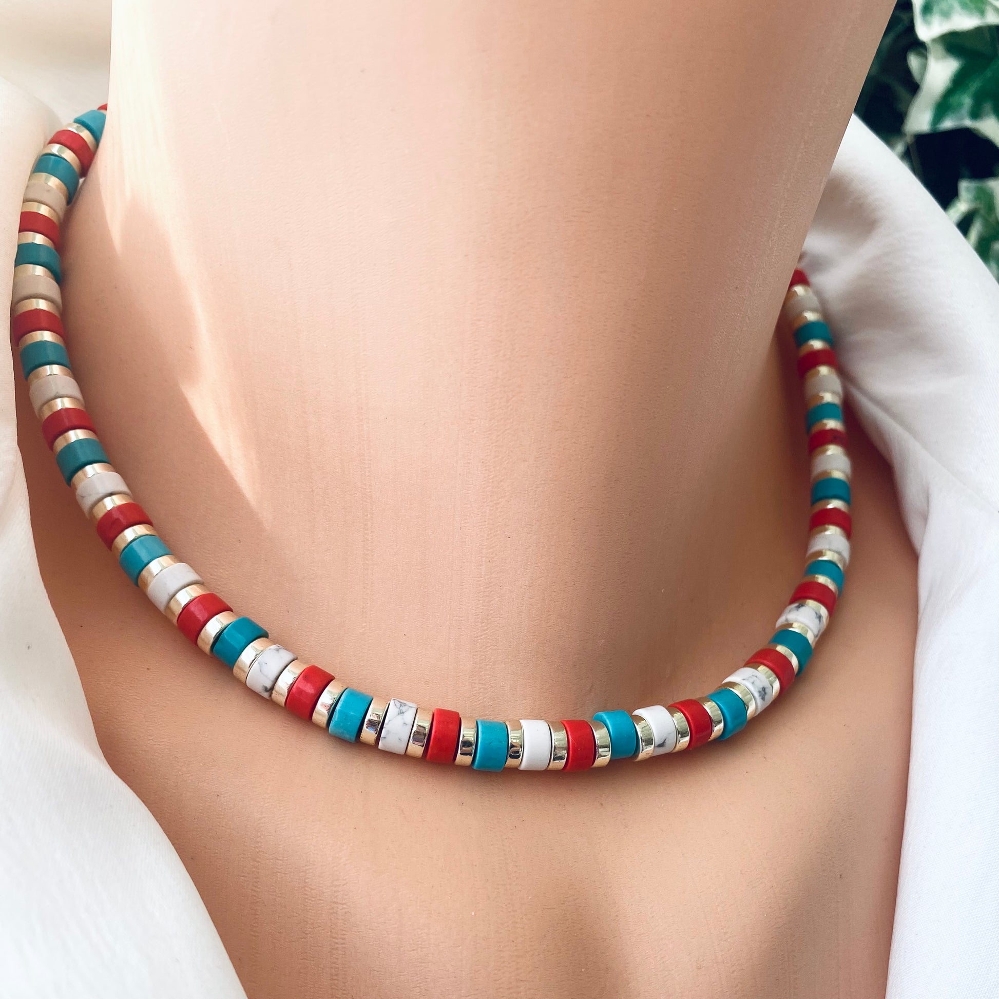 Gemstone choker necklace showcasing multi-color beads in red, turquoise, and white, perfect for colorful style.