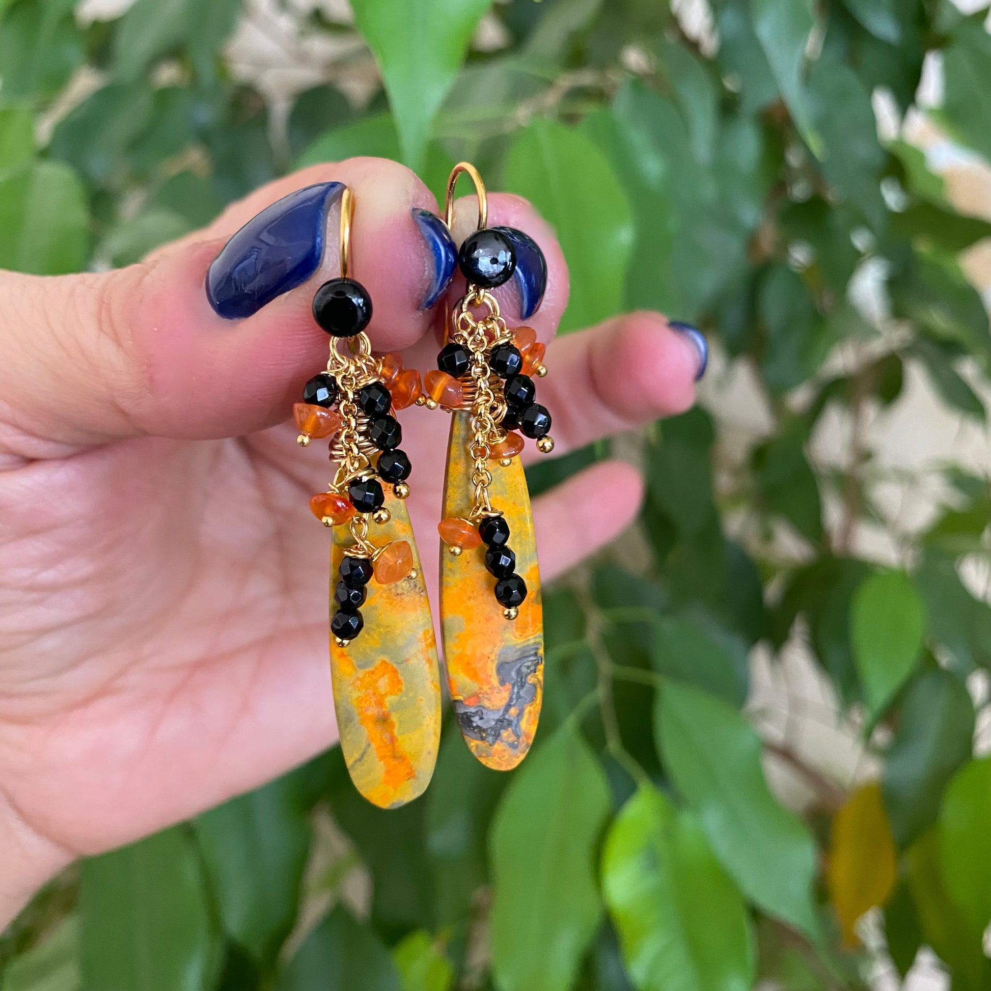 Bumble Bee Jasper earrings with bold yellow, orange, and black stone patterns, enhanced by Carnelian and Onyx clusters.