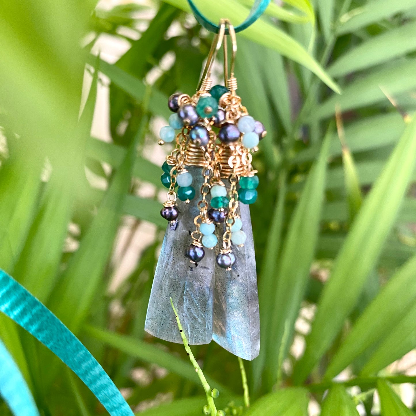 Labradorite amazonite green onyx black pearl earrings photographed outdoors with natural light