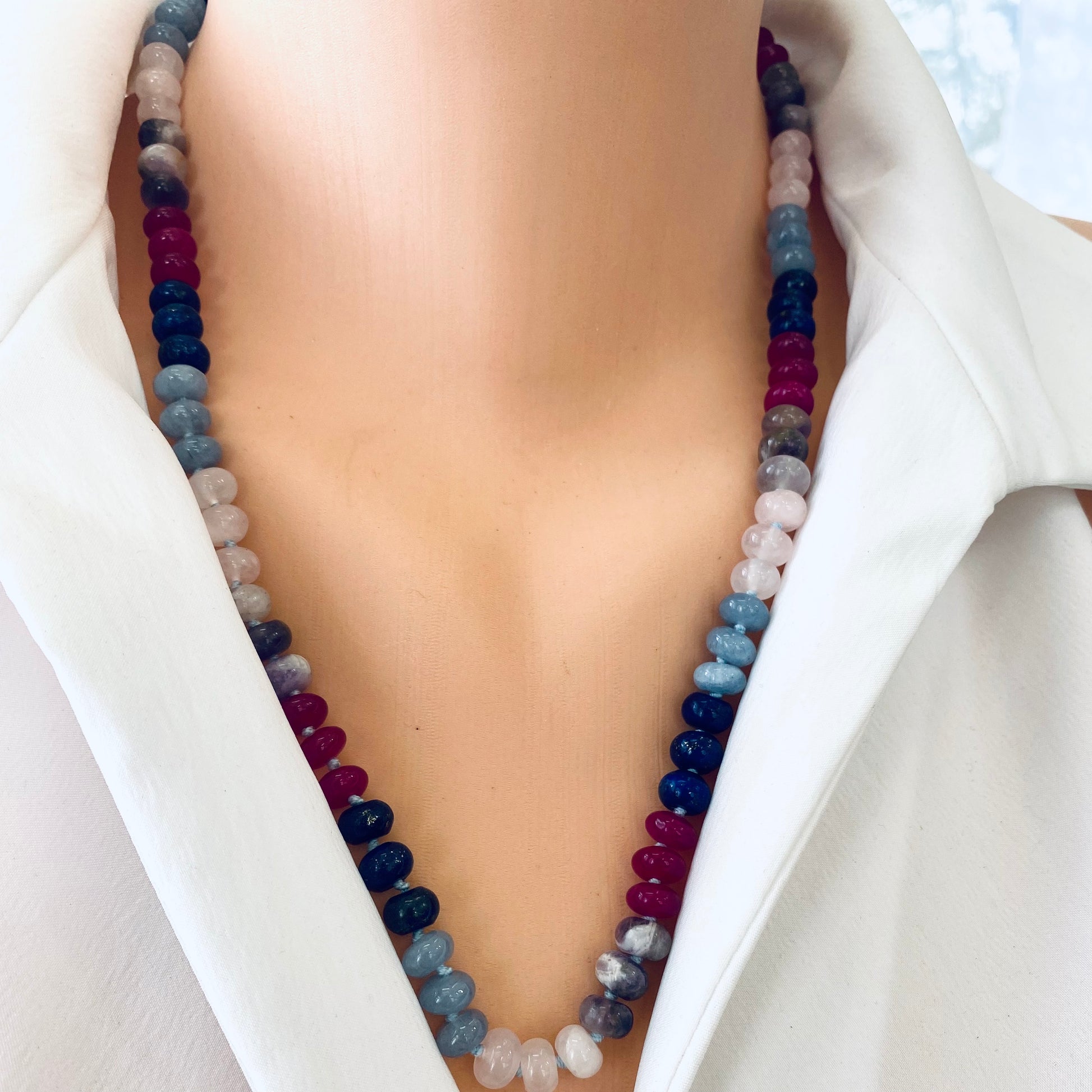 Denim candy necklace featuring lapis lazuli, rose quartz, jade beads worn on a mannequin's neck.