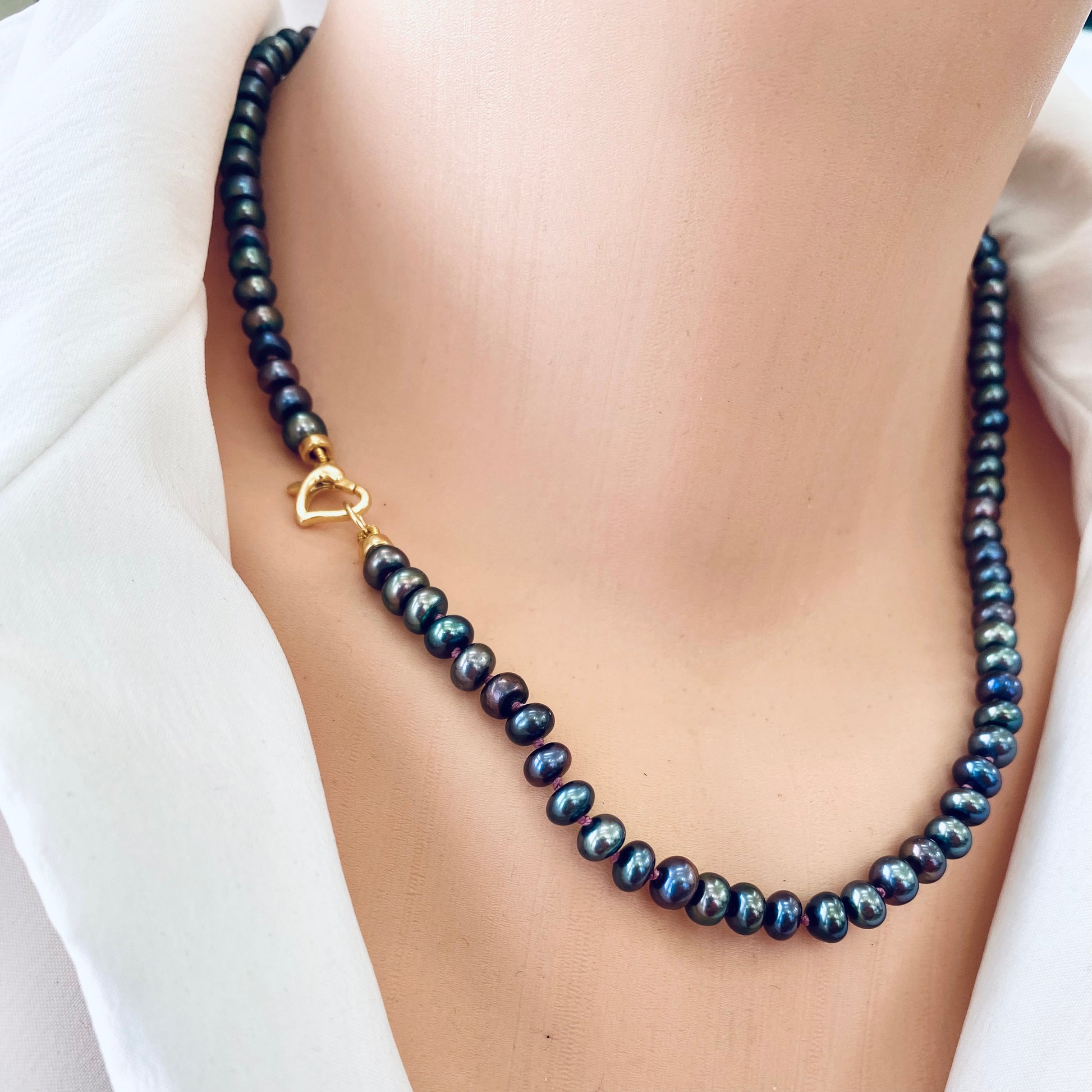 Black pearl necklace with chalcedony and chrysoprase styled as classic pearl strand without pendant
