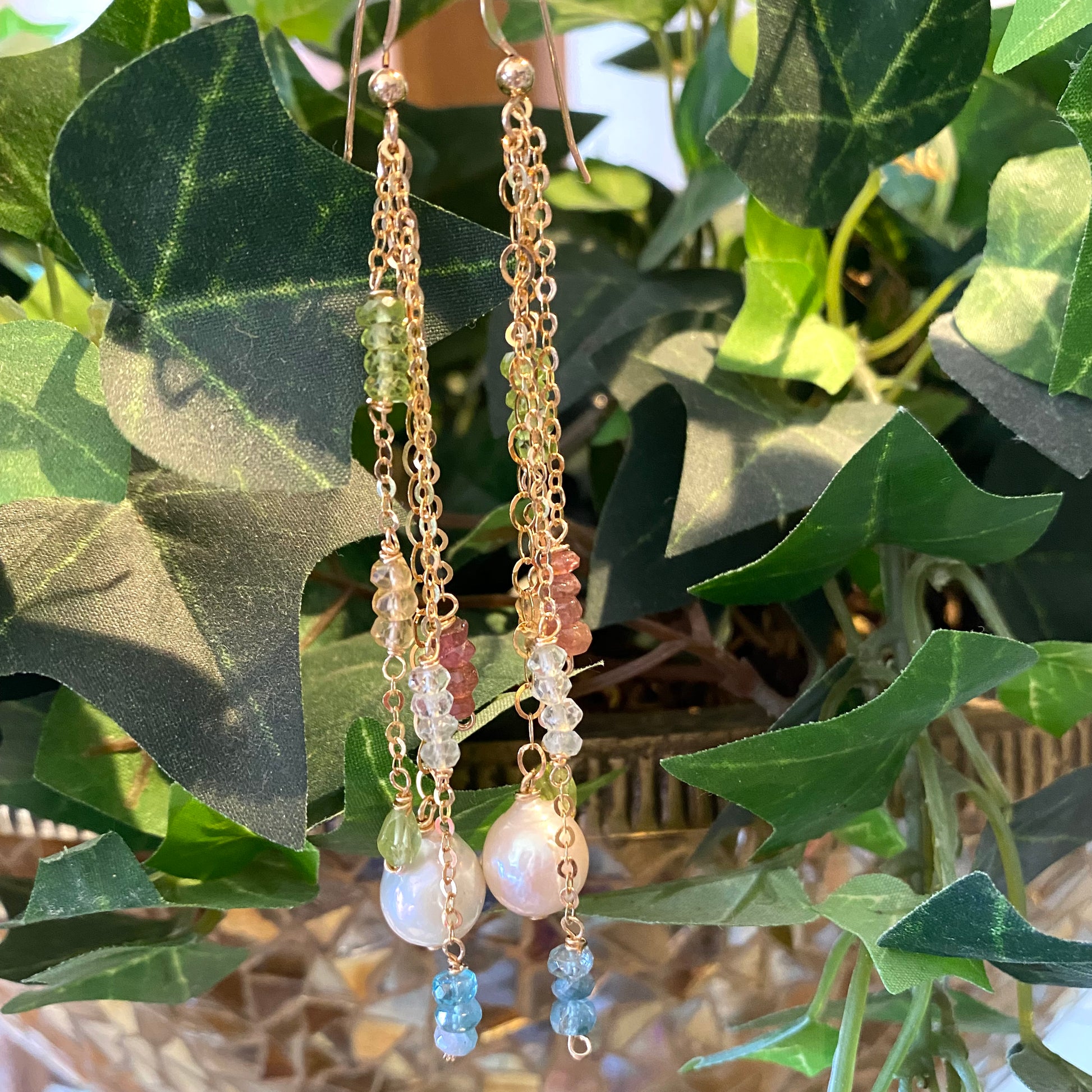 Baroque pearl gemstone earrings hanging on natural greenery handmade Canadian jewelry