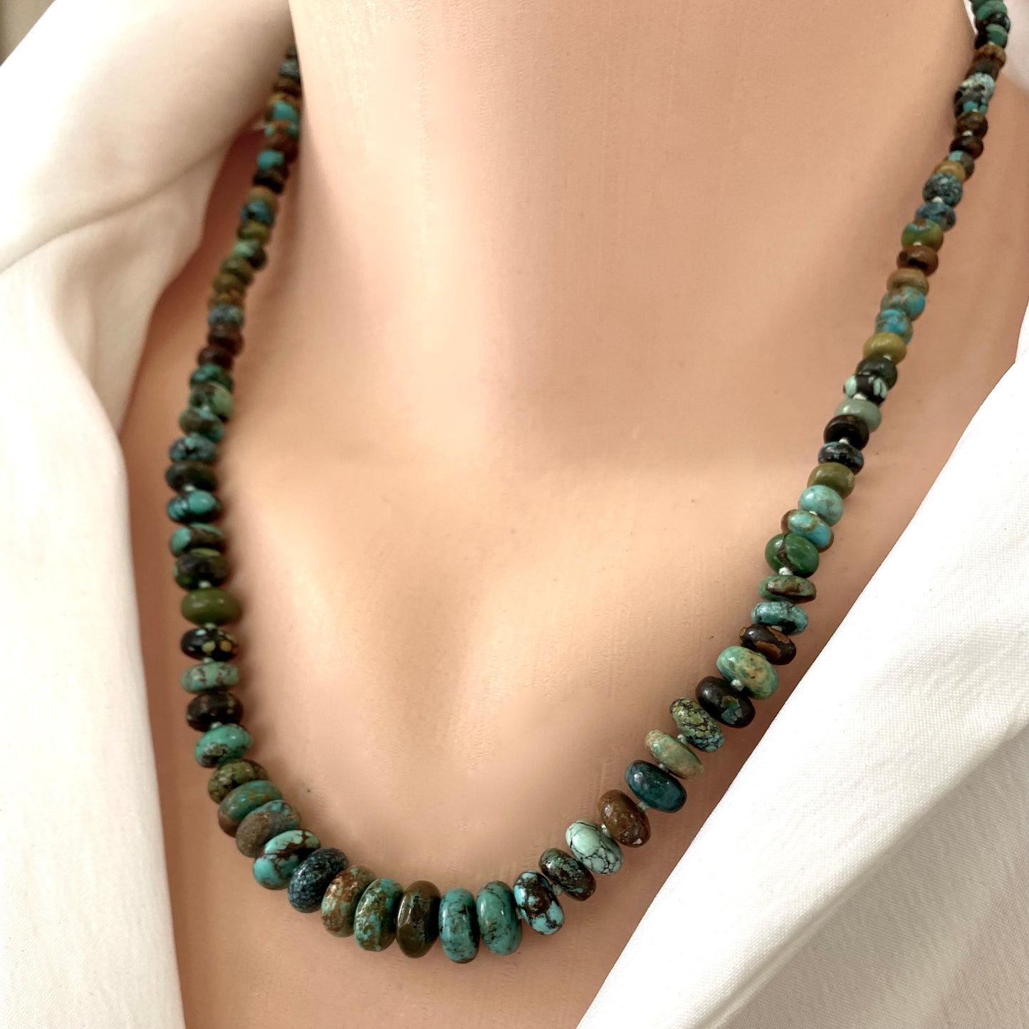 Turquoise necklace gold filled close-up on model, earthy turquoise bead strand layered at neckline