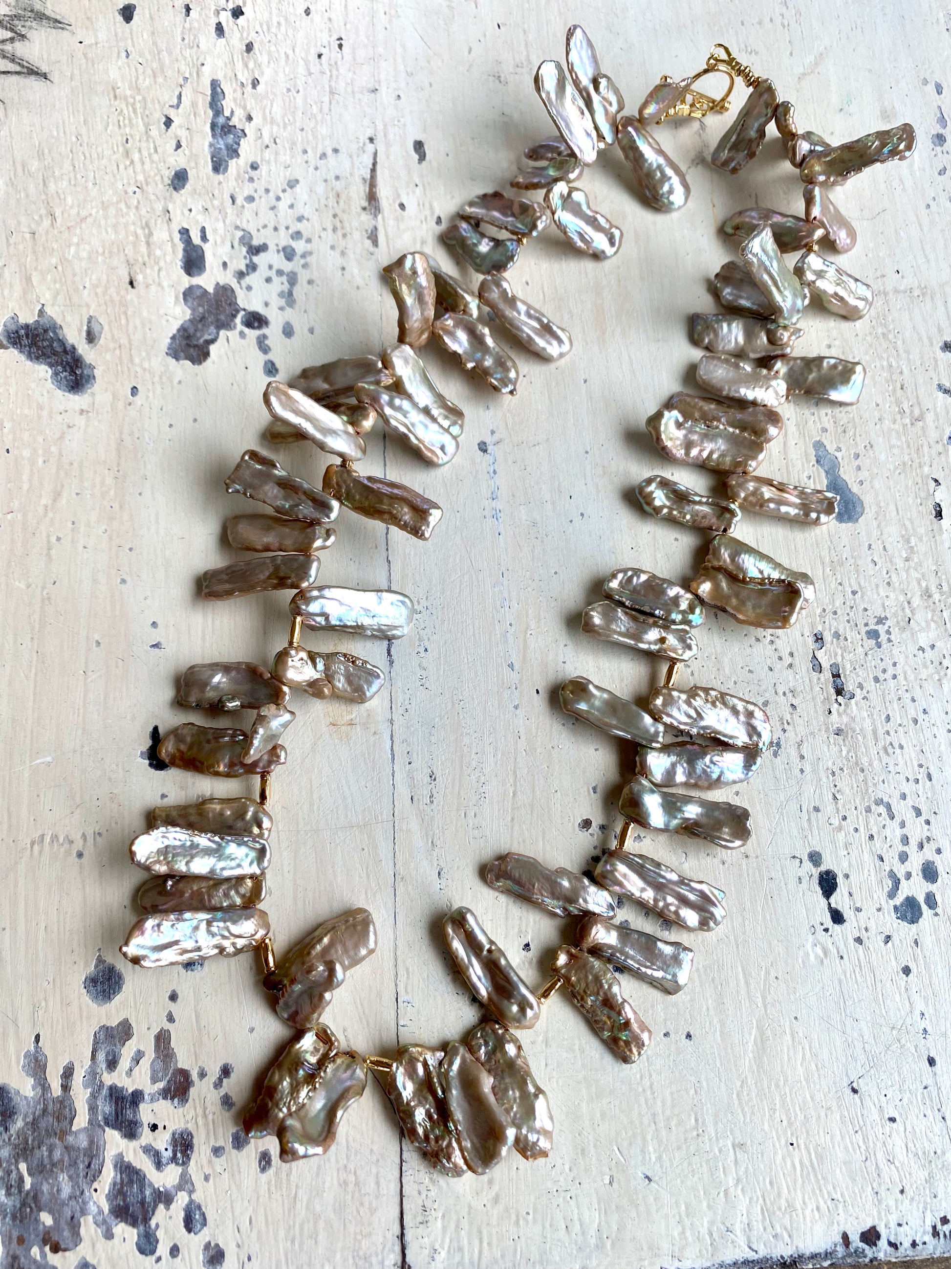 Champagne pearl necklace flat lay, organic Biwa keshi stick pearls with vermeil toggle clasp