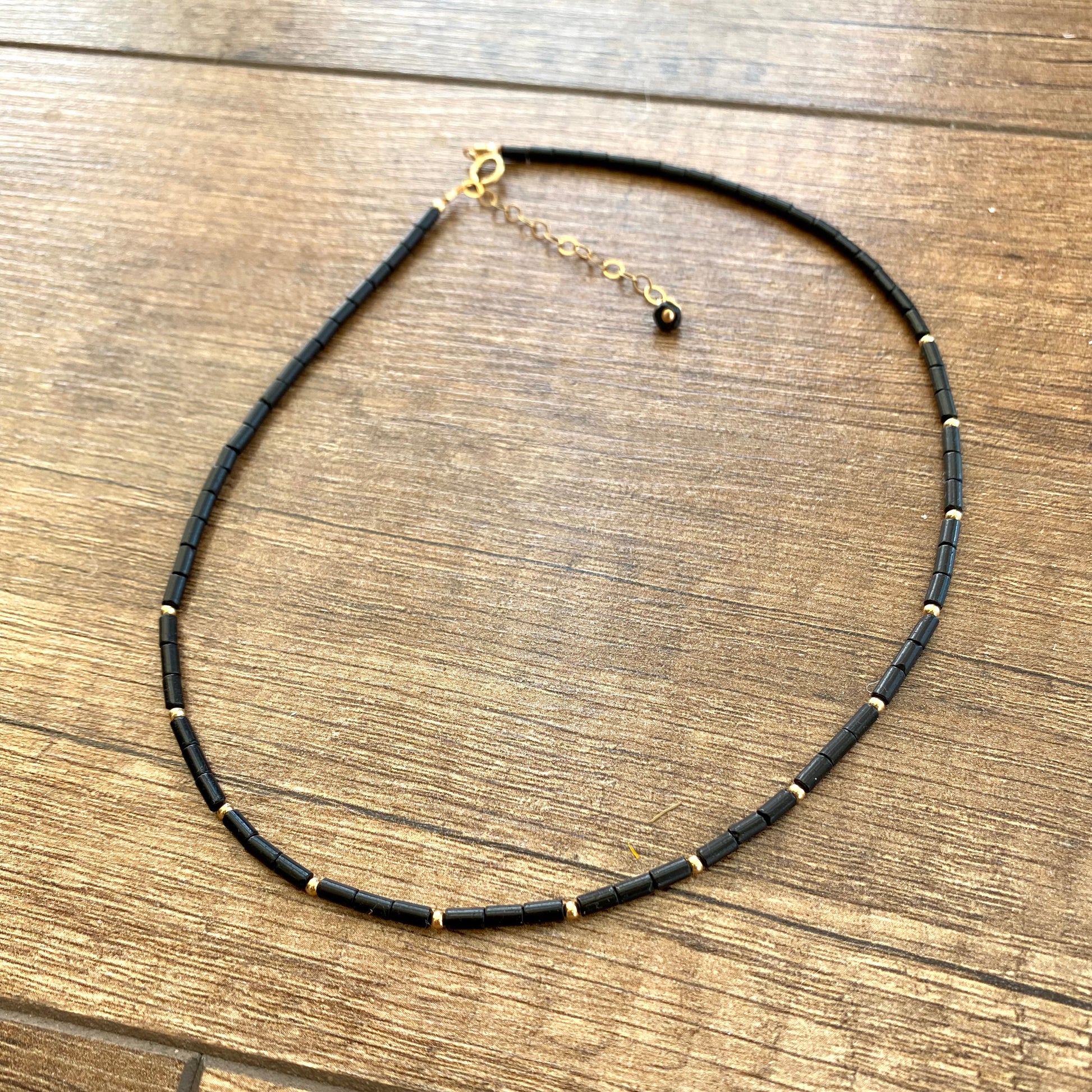 Lapis lazuli onyx choker necklace displayed flat showing black onyx tube beads