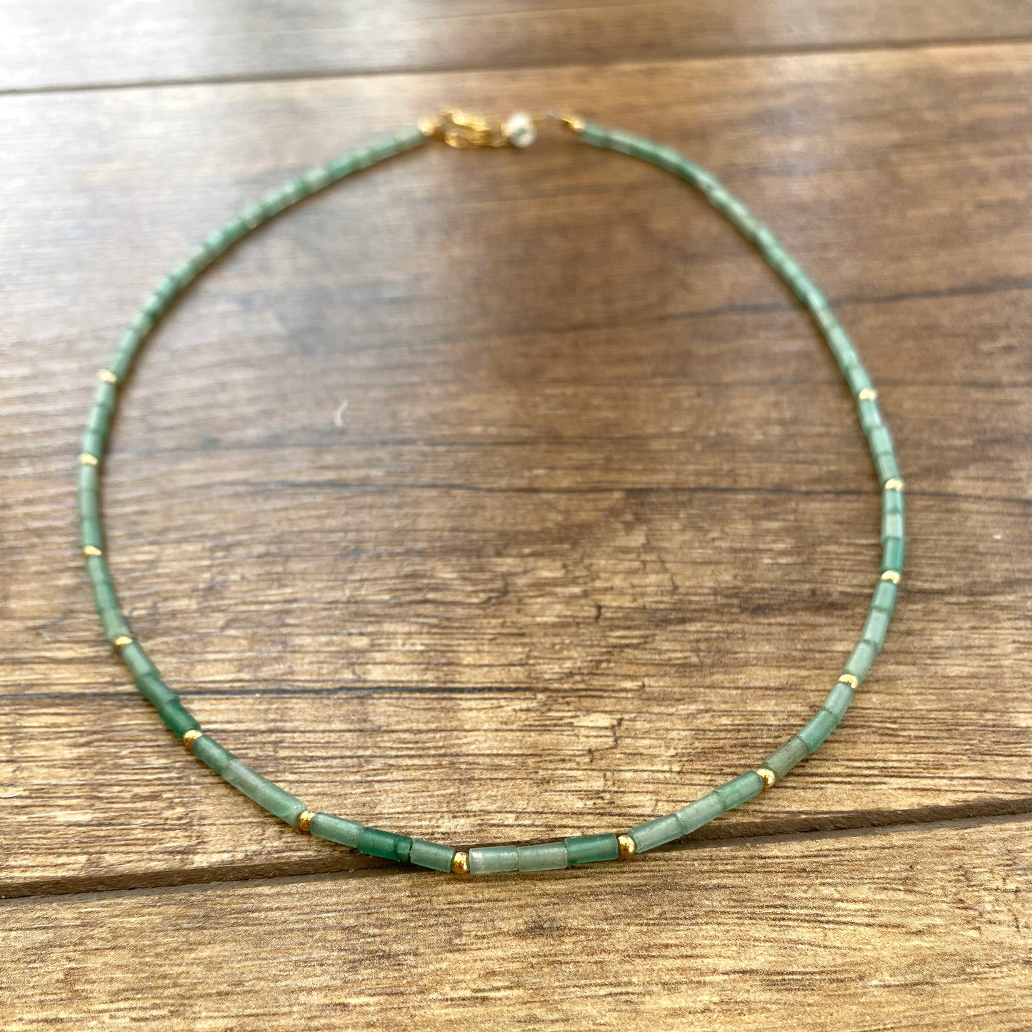 Lapis lazuli onyx choker necklace with green onyx beads displayed on wood surface