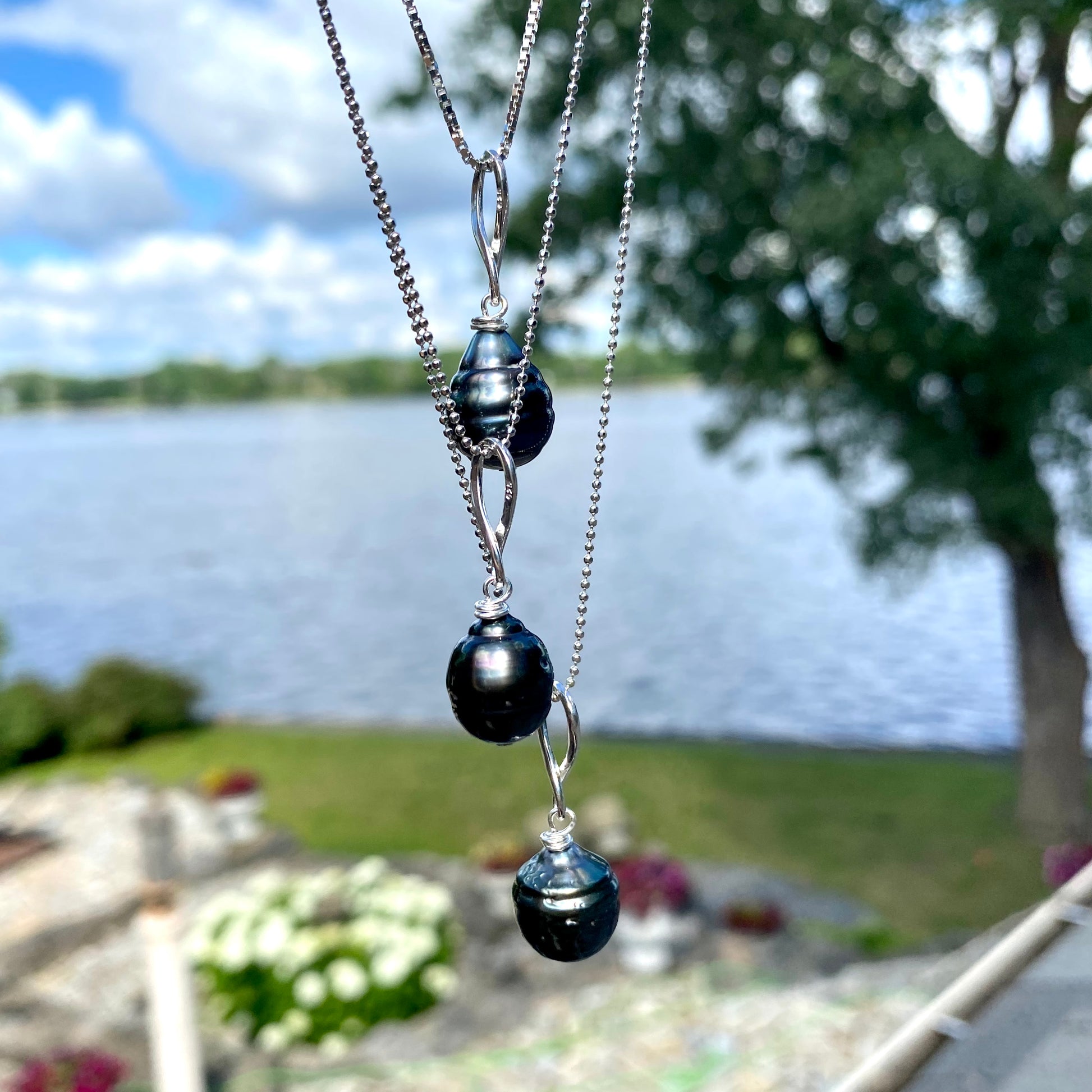 Tahitian teardrop pearl pendant necklace outdoors by the water, genuine Tahitian pearl on silver ball chain
