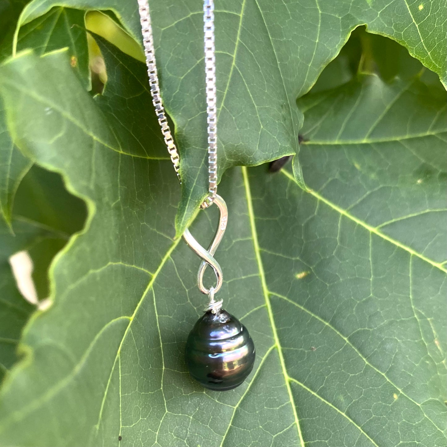 Tahitian teardrop pearl pendant box chain on green leaf, sterling silver chain with dark pearl pendant
