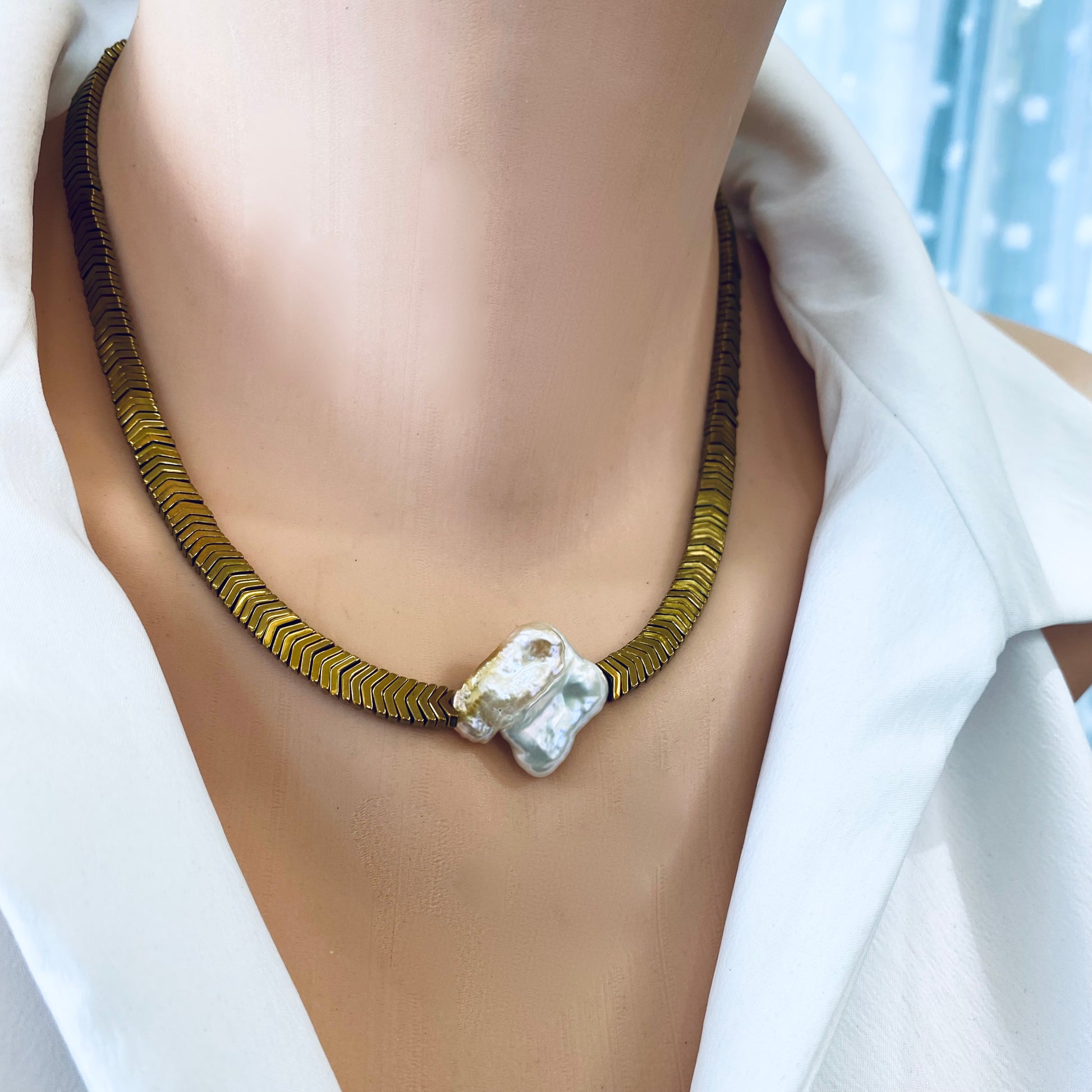 Gold hematite keshi pearl necklace worn on model showing bold gold hematite beads and square pearl