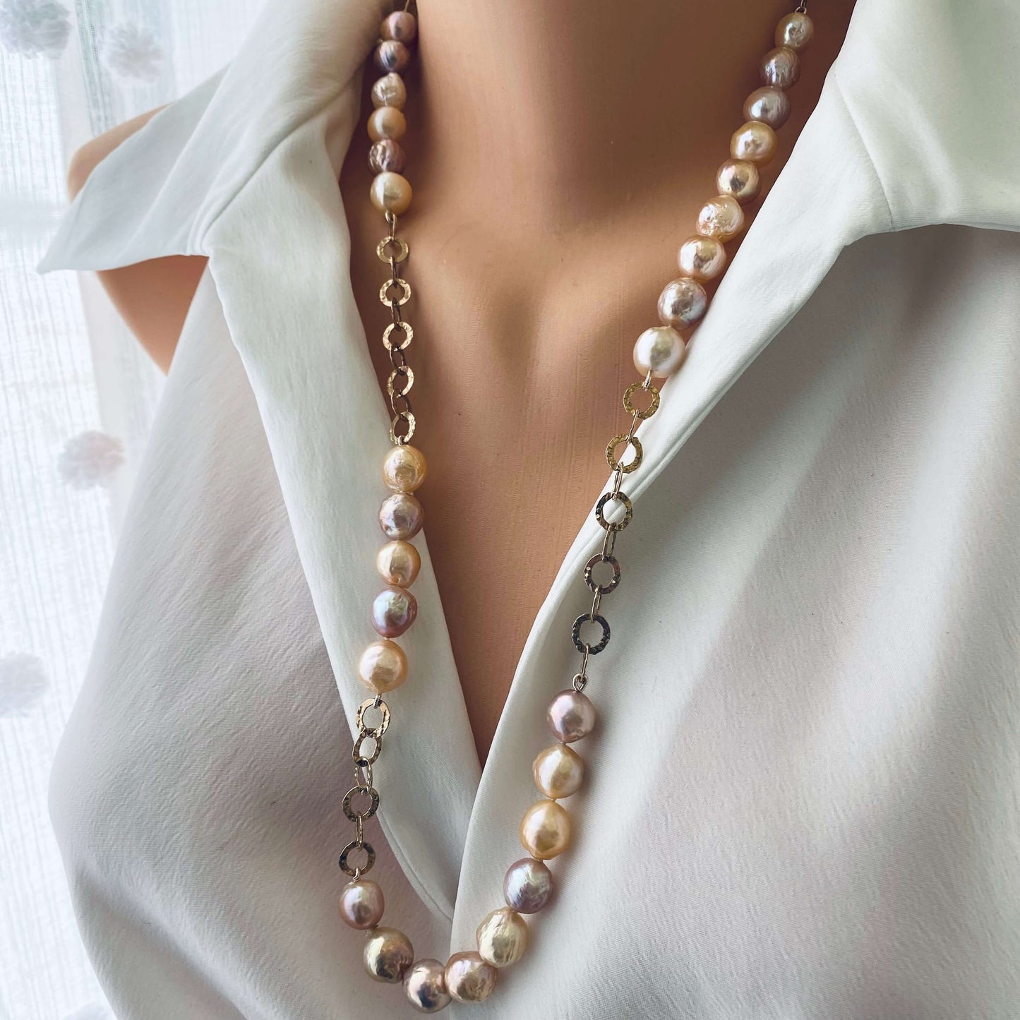 Edison pearl necklace with wrinkled pearls in rose gold showcased on a mannequin against a light background.