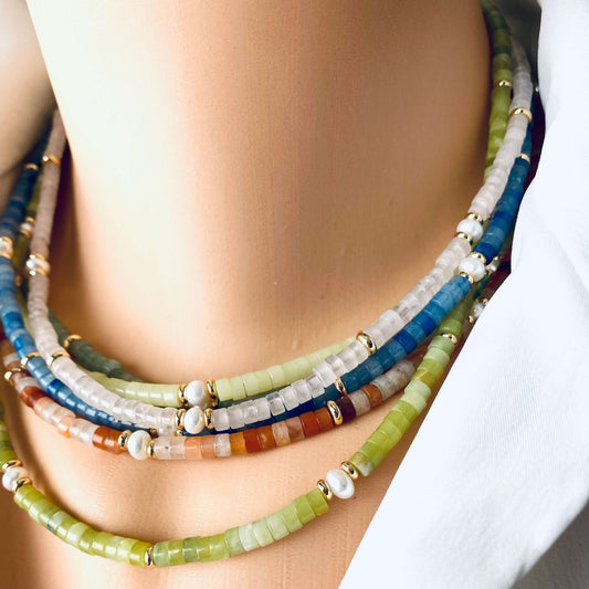 Multi gemstone choker necklaces layered on model with pearls and colorful gemstone beads
