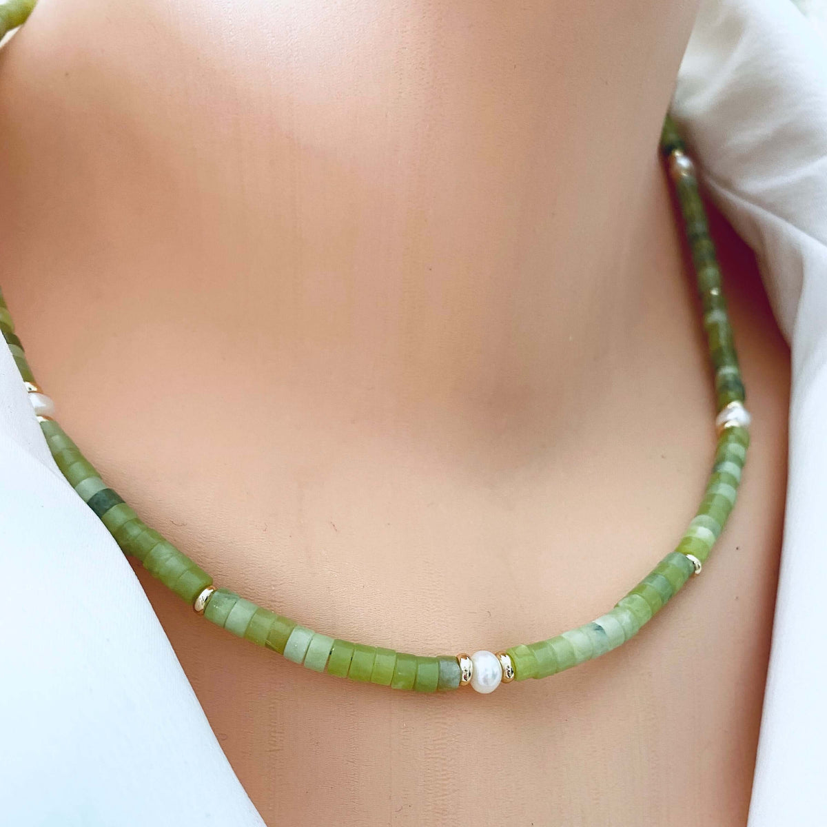 Multi gemstone choker necklaces worn at the neckline with green jade beads