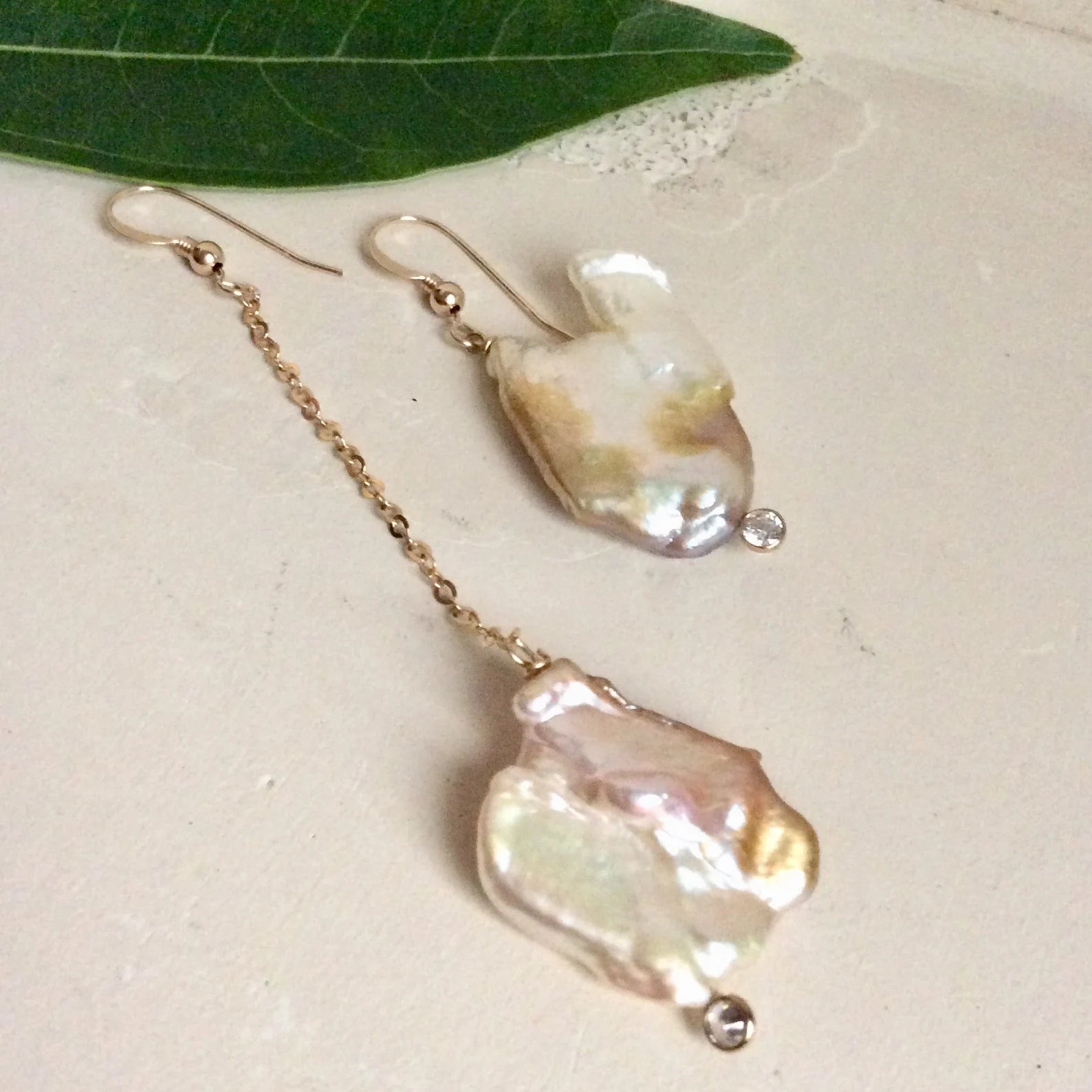 Mismatched Pearl Drop Earrings featuring unique asymmetrical designs and clear CZ accents, handcrafted with 14k gold filled.