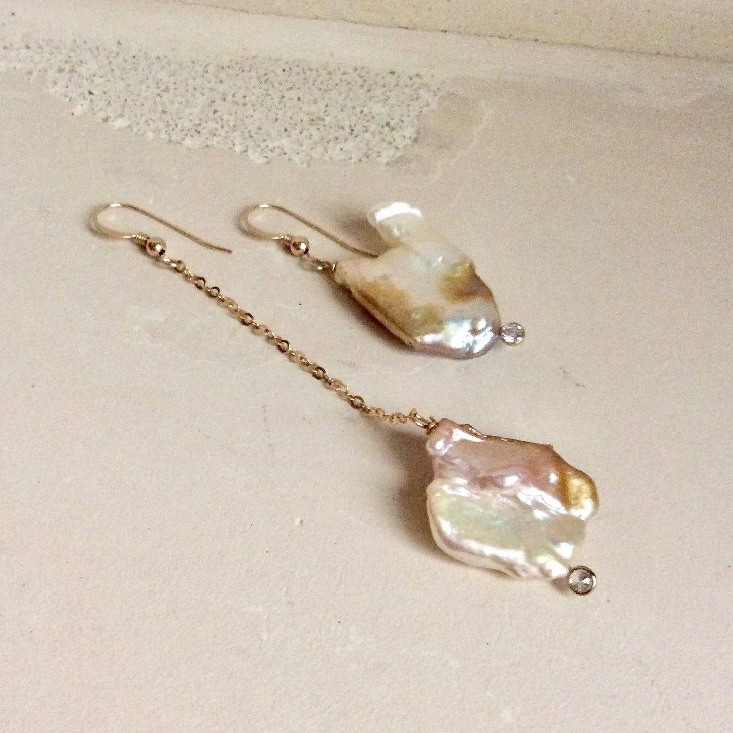 Mismatched Pearl Drop Earrings featuring asymmetrical pearls with clear CZ, 14k gold filled detail.