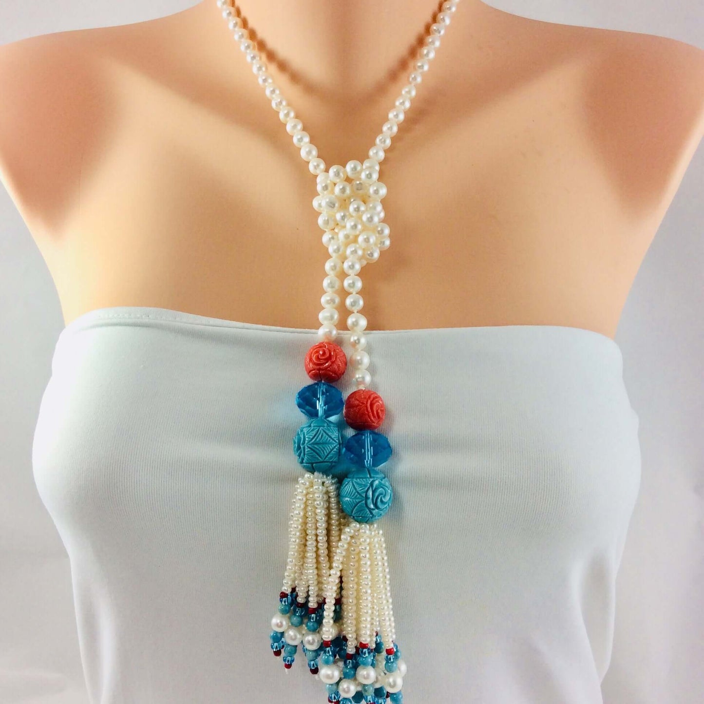 pearl coral turquoise lariat necklace showcasing handcrafted pearls and coral flowers, evoking coastal artistry and summer romance.